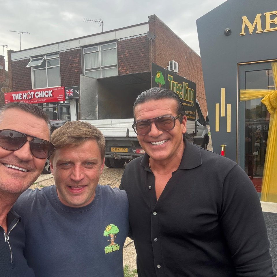 Mitch King, centre, with guests beside a Tree King vehicle
